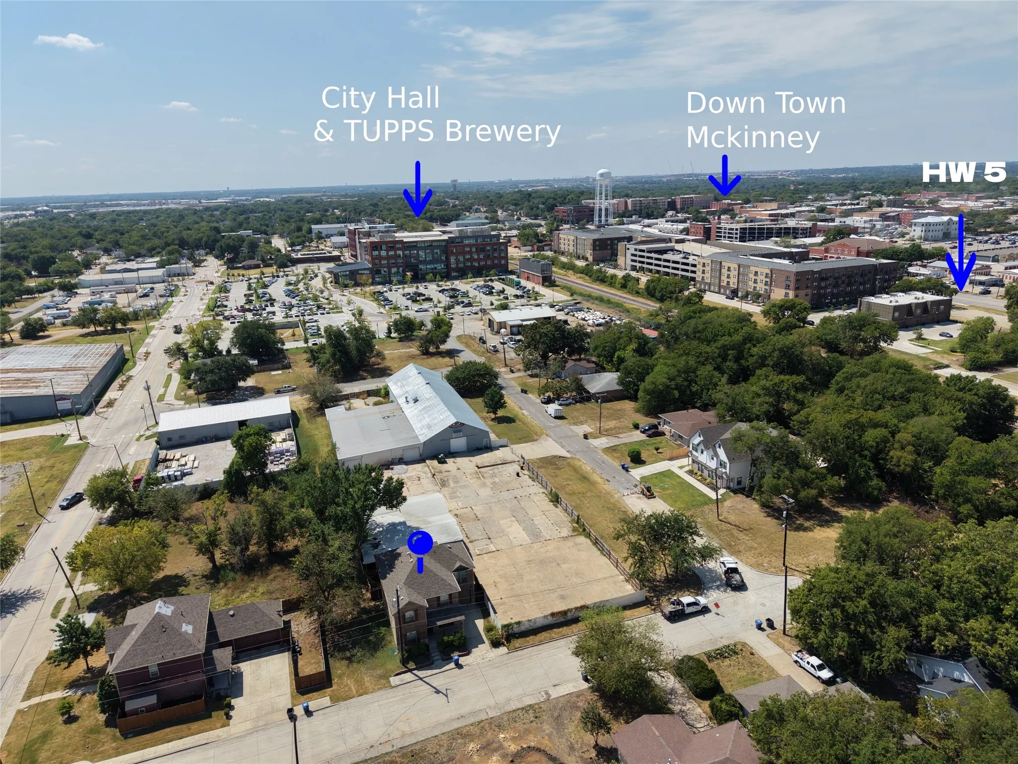 Aerial perspective of the property, surrounded by mature trees