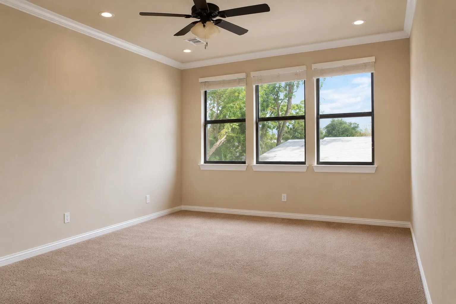 Recessed lighting, crown molding, ceiling fan, triple windows, and neutral carpeting