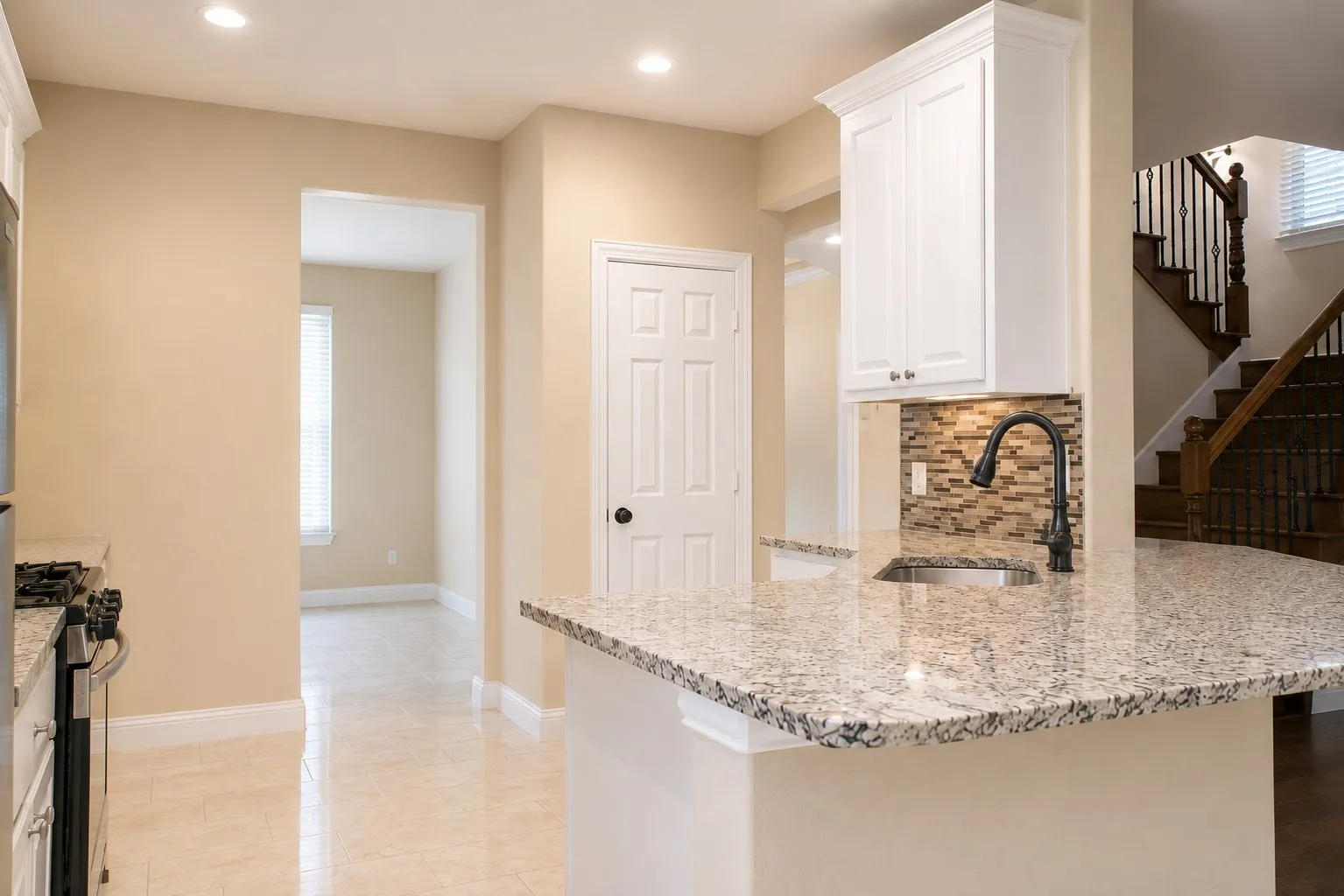 Kitchen island with granite countertop, integrated sink, and gooseneck faucet
