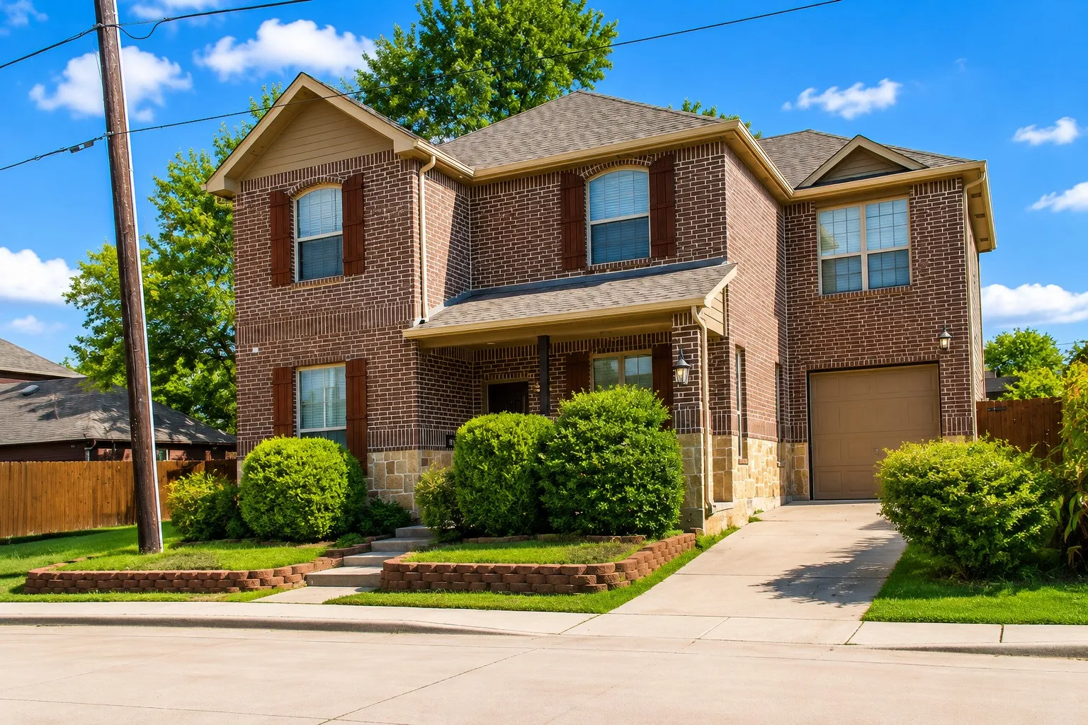 Brick exterior with stone accents, covered porch, and attached garage