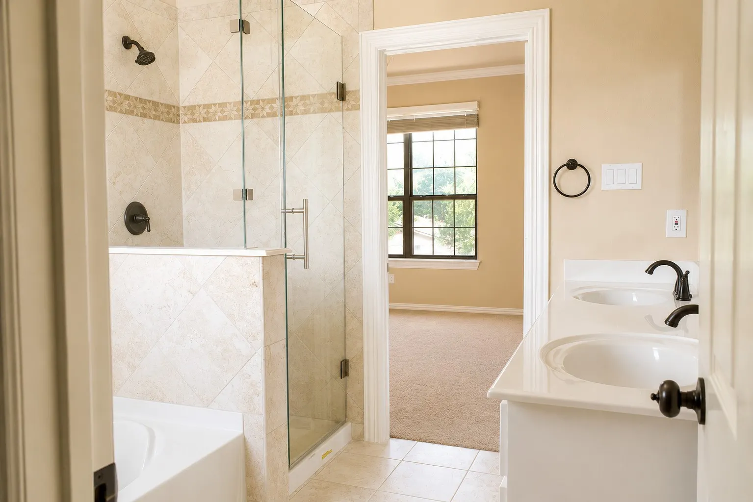 Dual vanity with white countertops, undermount sinks, and matte black fixtures