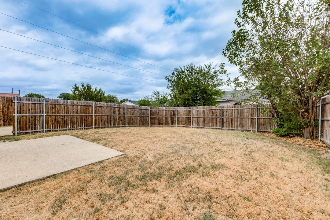 Expansive backyard featuring full perimeter wood fencing