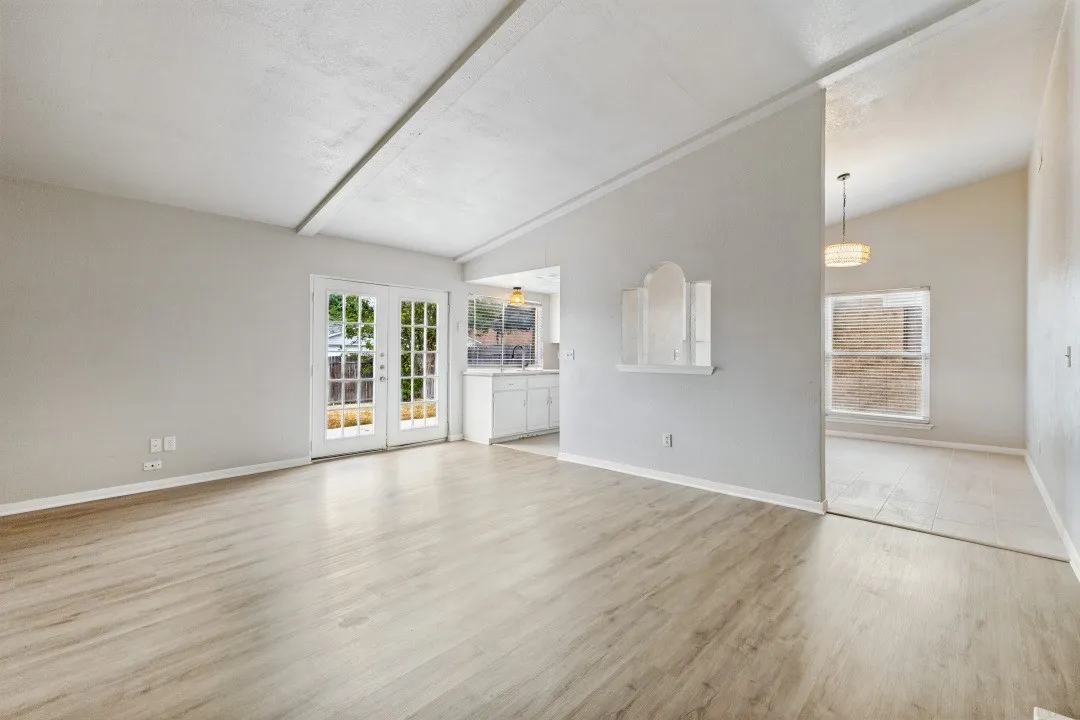 The living room adjoins the formal dining room and the kitchen