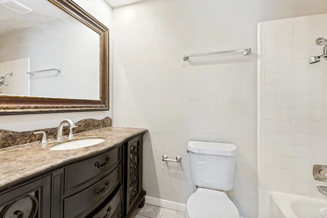 Dark wood vanity with an integral sink and a decorative countertop