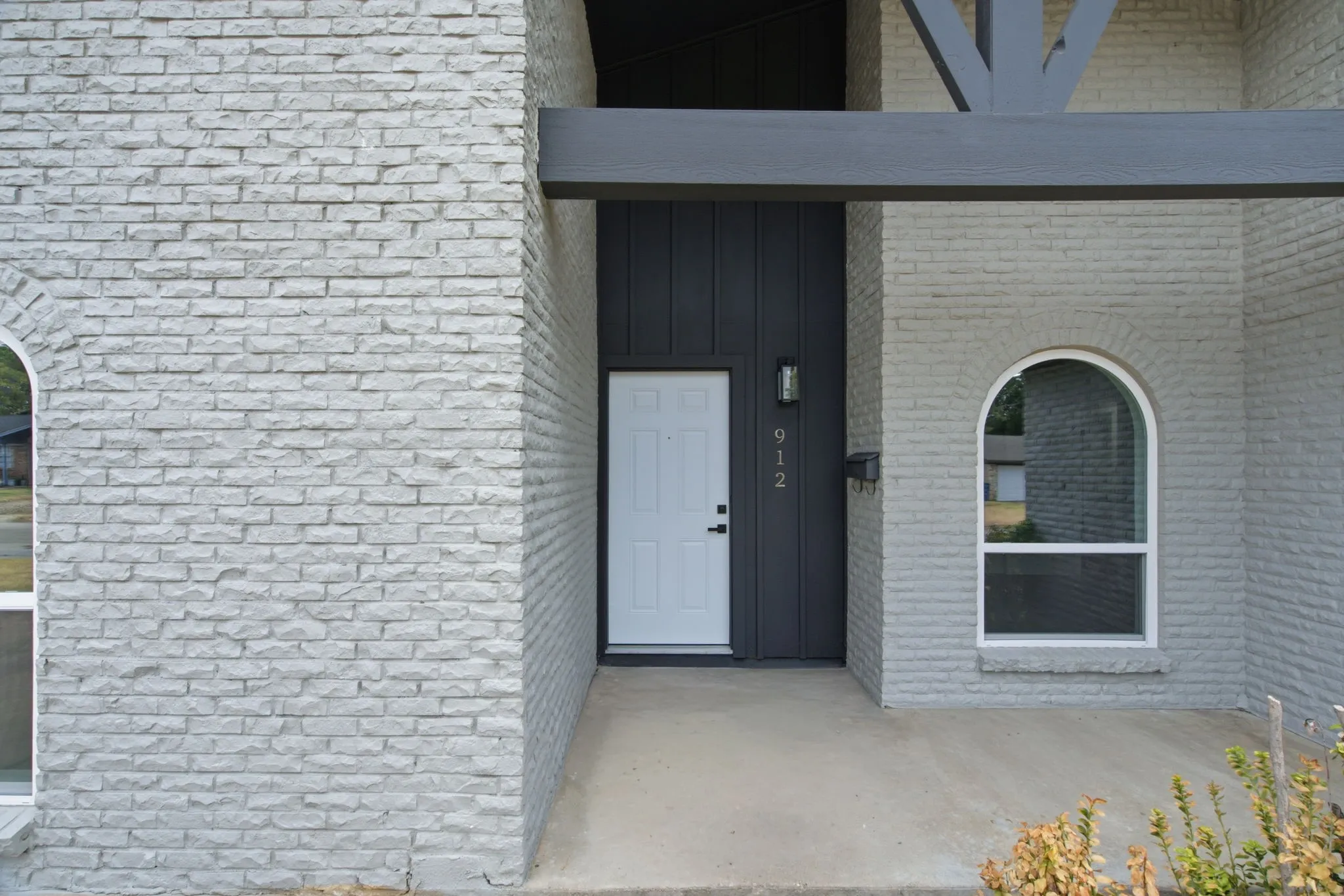 White brick facade with dark accent paneling