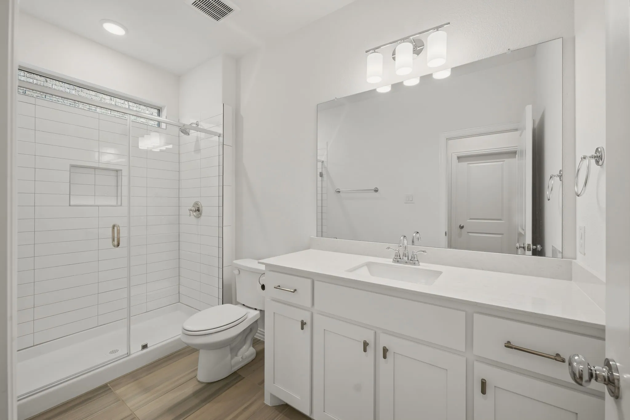 Shower with horizontal subway tile and built-in niche