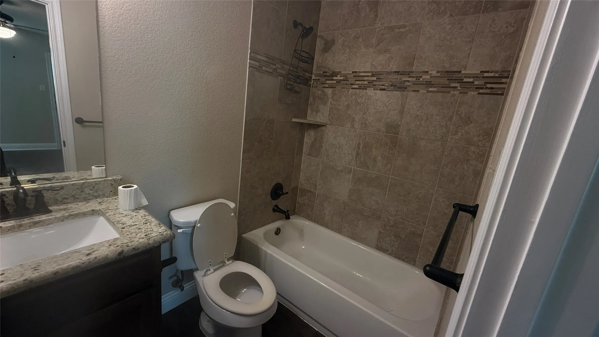 Tiled tub and shower combination with a decorative mosaic accent band