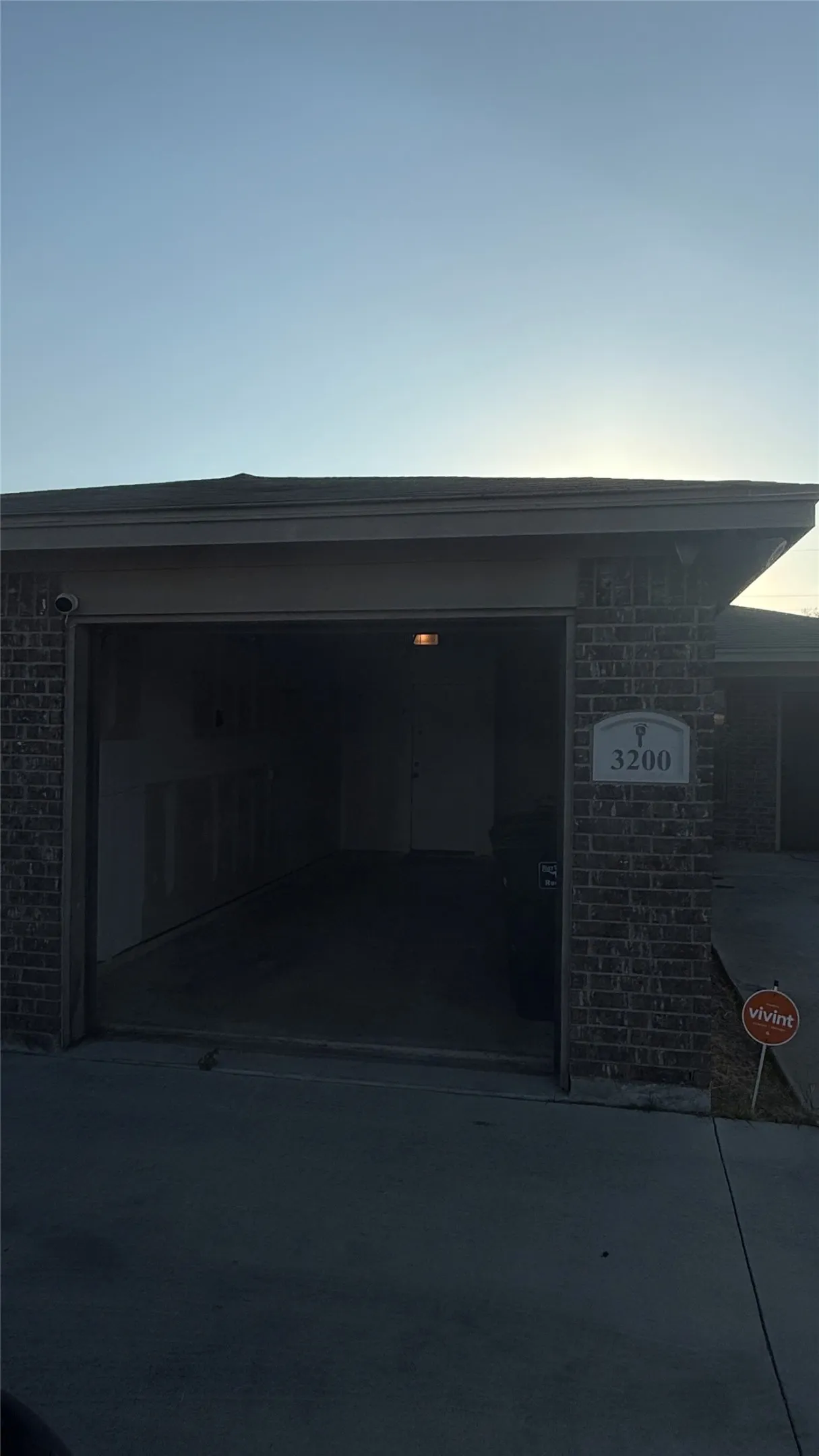 Brick exterior with attached garage and concrete driveway