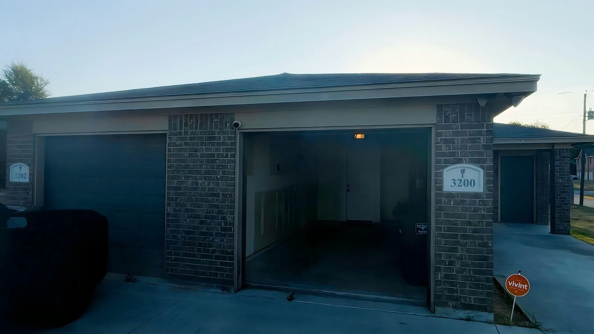 Brick exterior with a covered entryway and attached garage