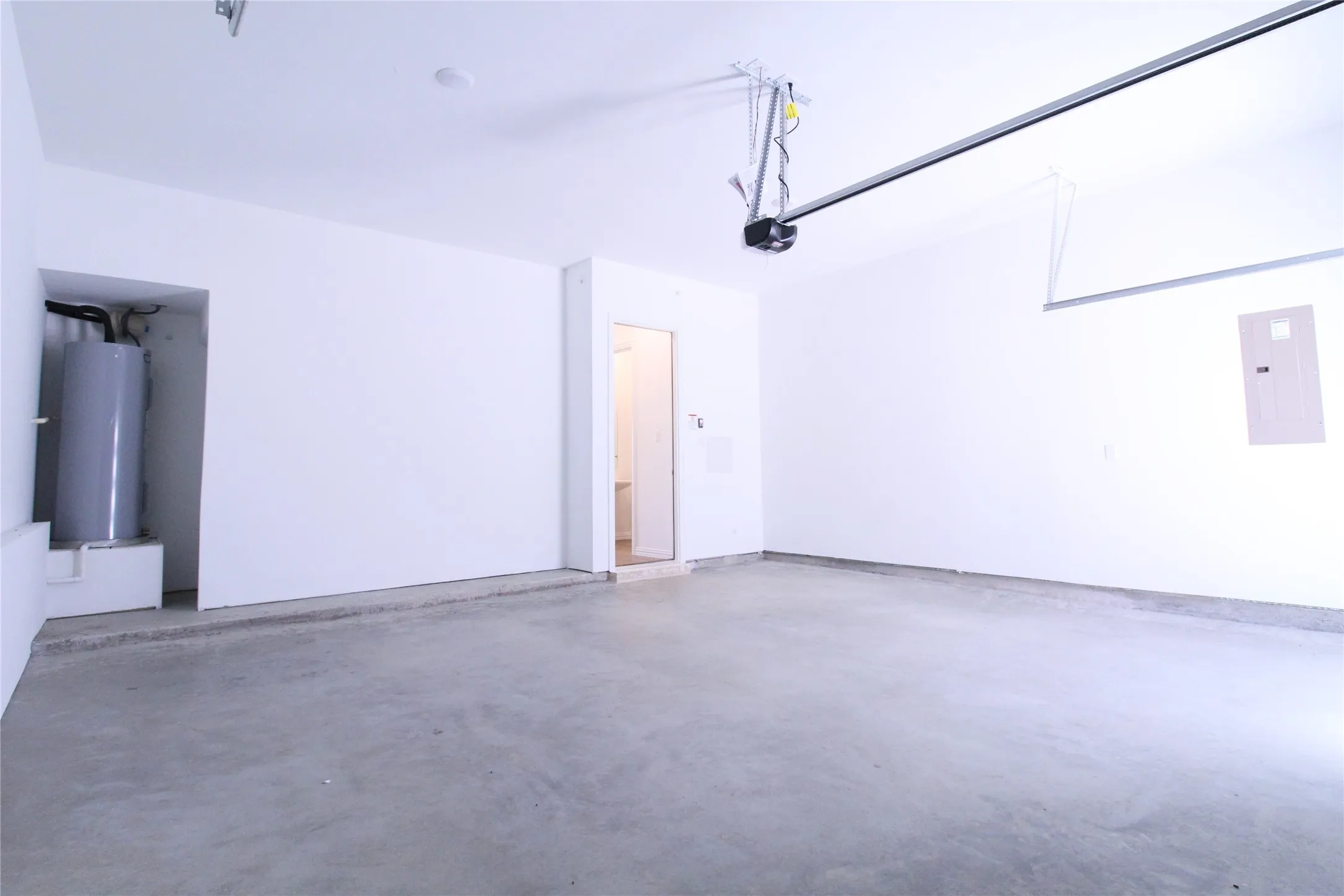Spacious garage with concrete flooring and bright white walls