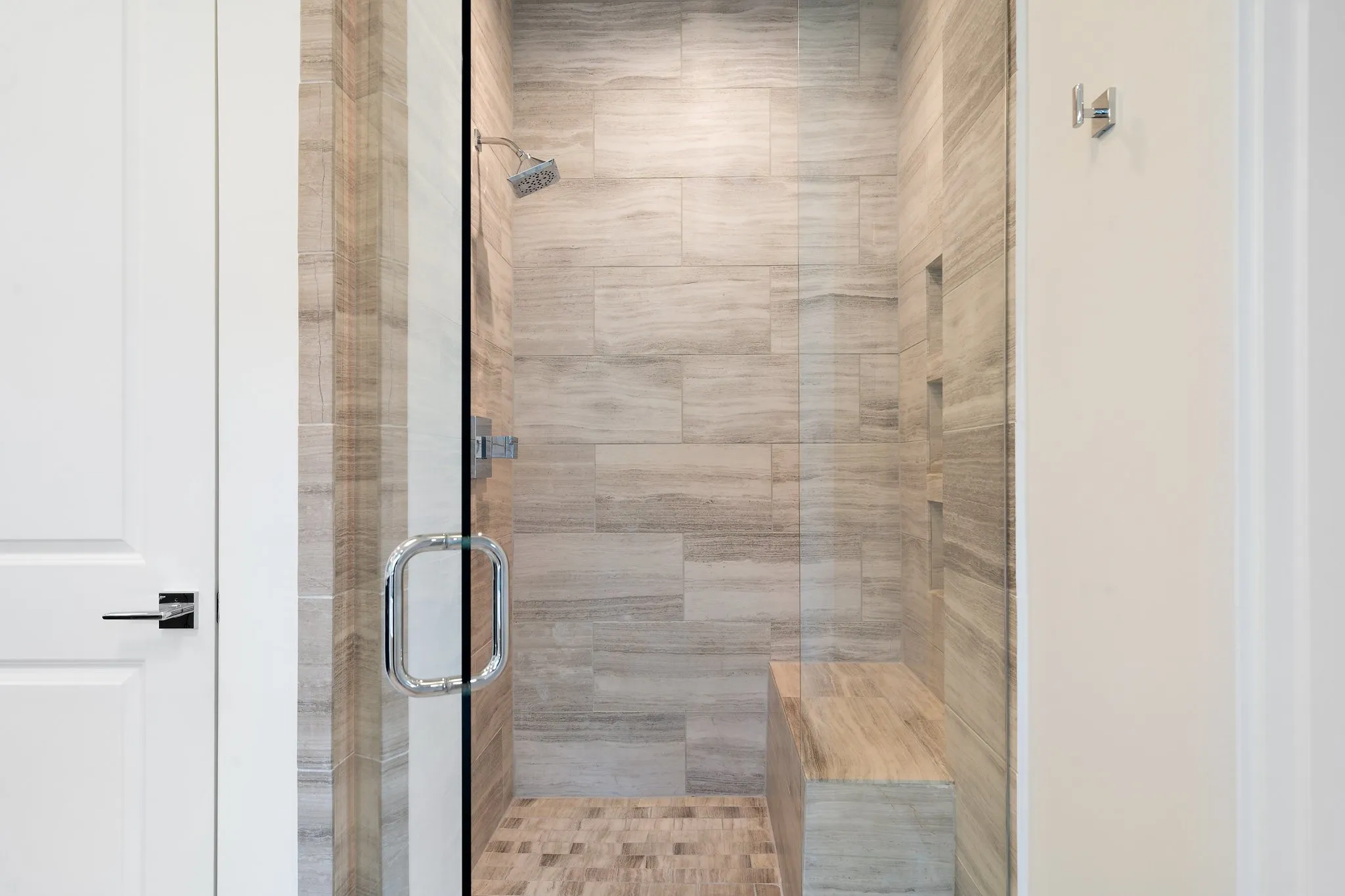 Curated tile selections give each bath a fresh, designer-forward feel.