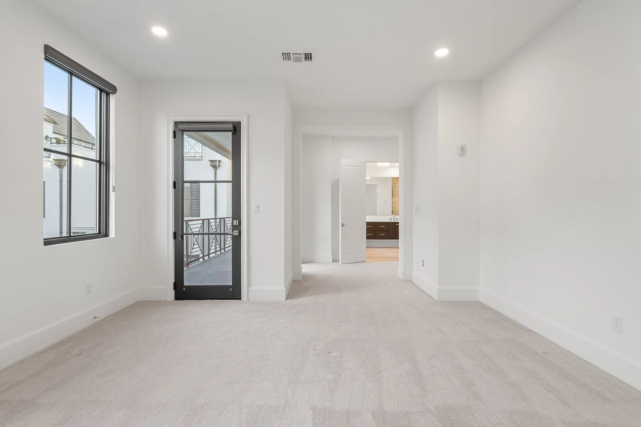 The private primary suite opens directly to the balcony for a seamless indoor-outdoor connection.