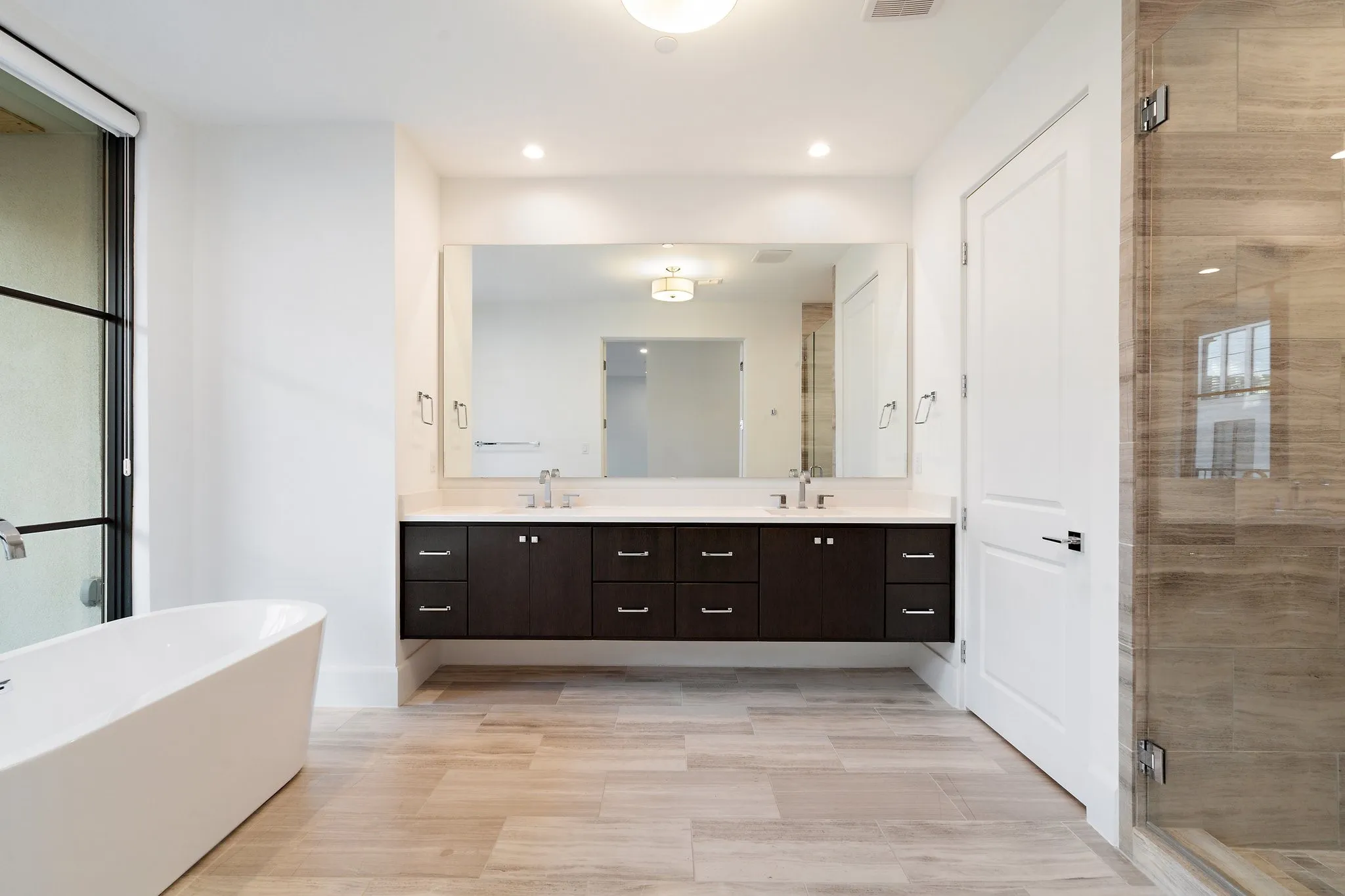 A spa-inspired primary bath offers a serene and sophisticated retreat.