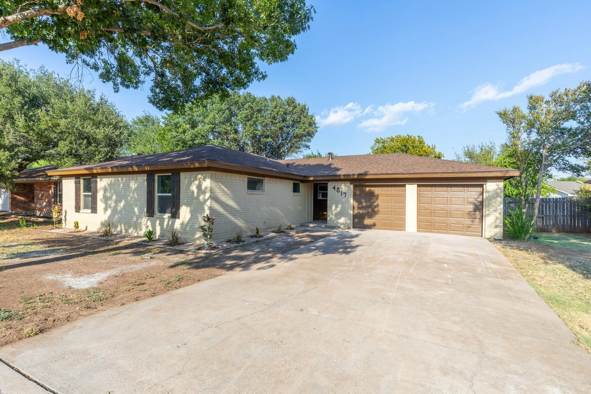 Brick exterior with a two-car garage and a concrete driveway