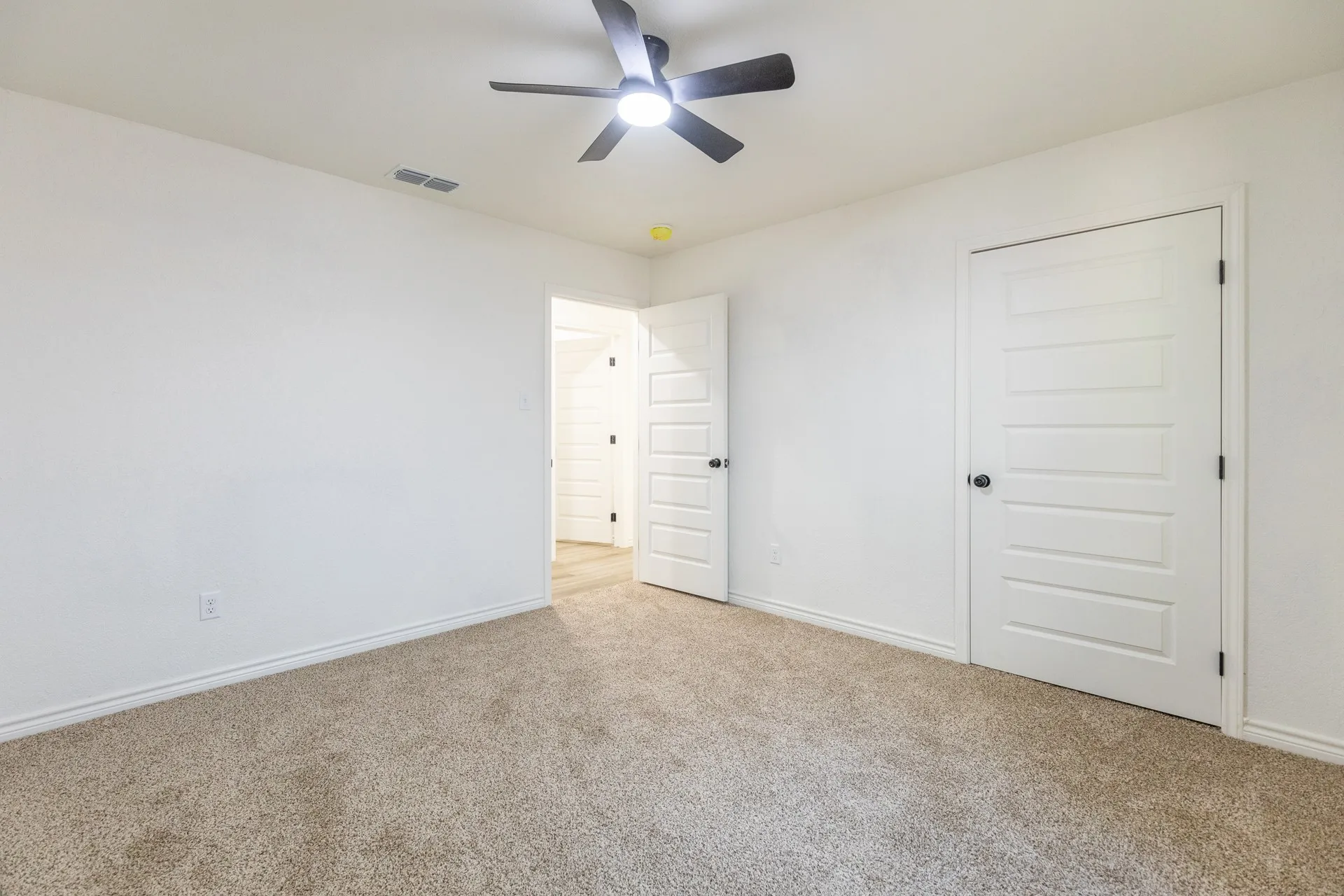 Recessed lighting, ceiling fan with light fixture, white interior doors, and neutral carpeting
