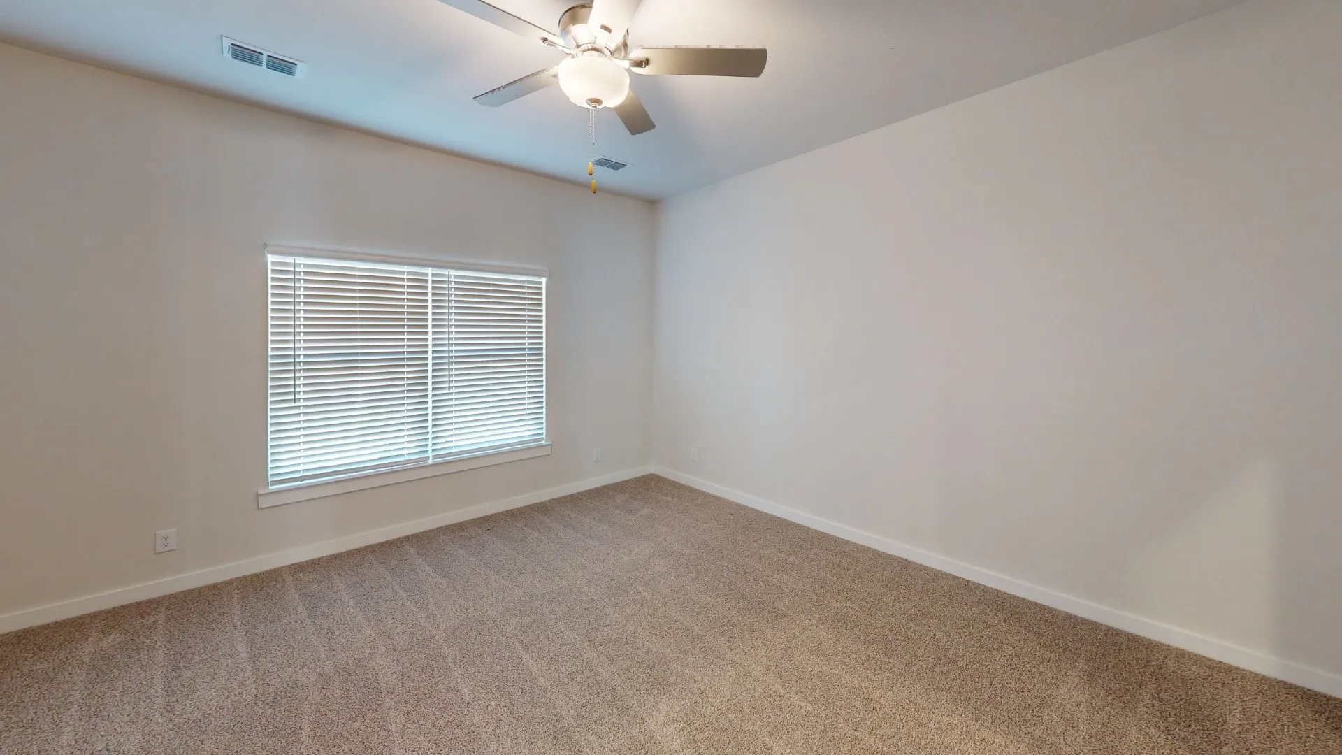 Neutral wall paint, plush carpet, and a ceiling fan with integrated lighting