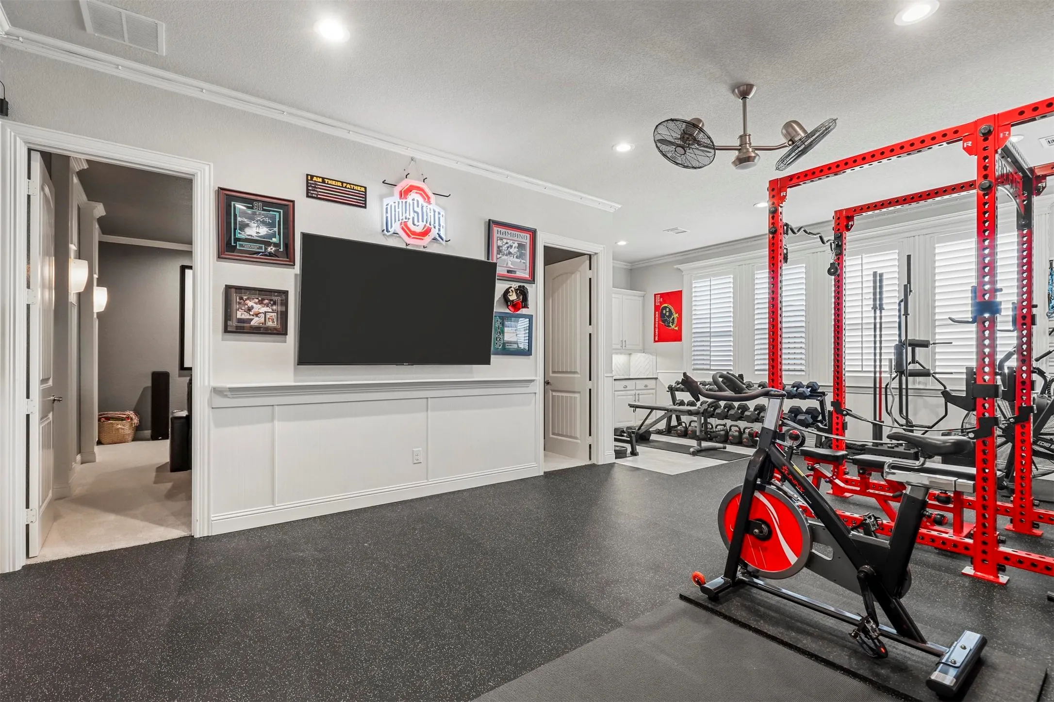 Rubberized flooring with integrated storage cabinetry and recessed lighting