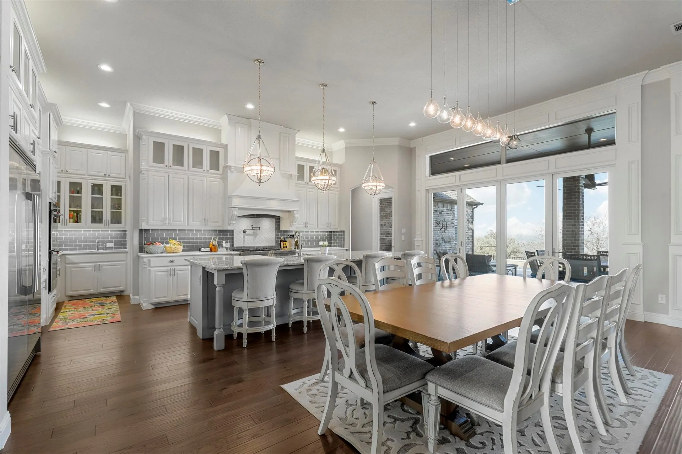 Kitchen with white cabinetry, a central island, stainless steel appliances, and a tile backsplash