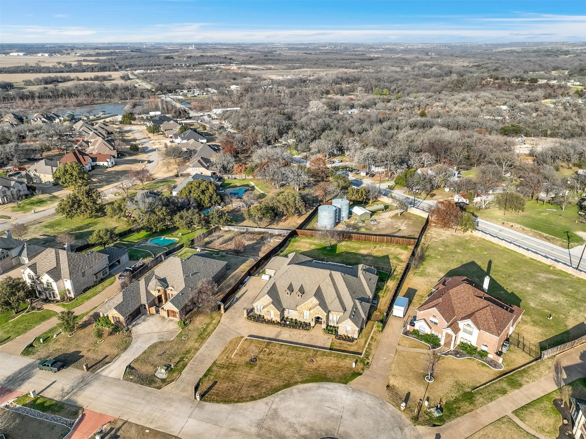 Aerial perspective showcasing the residential neighborhood with a distant body of water