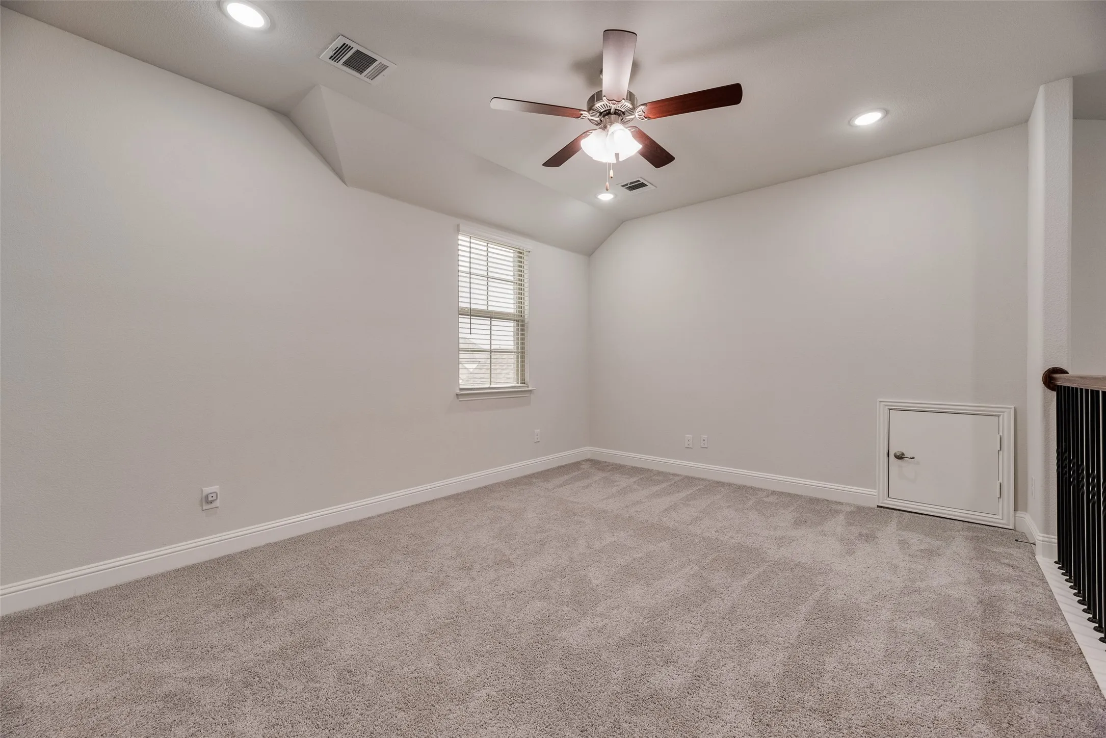 Carpeted room featuring a ceiling fan with light fixture, recessed lighting, and a window with blinds