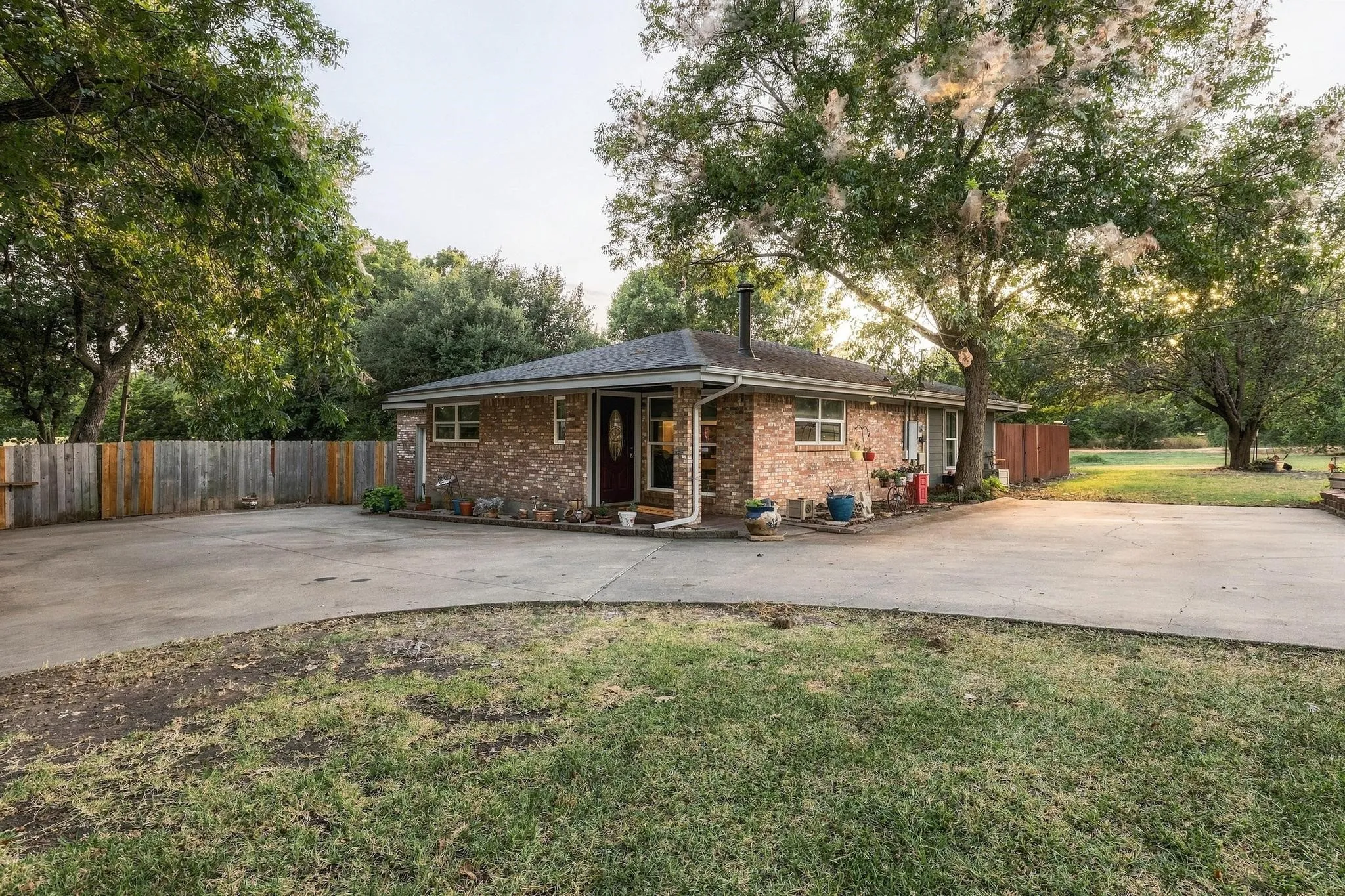 Front elevation of smaller home with shared driveway.
