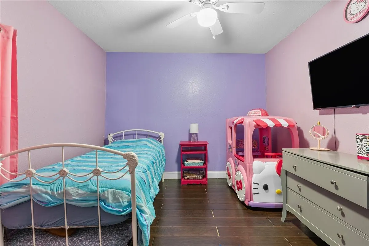Dark wood-finish flooring with light purple and lavender walls
