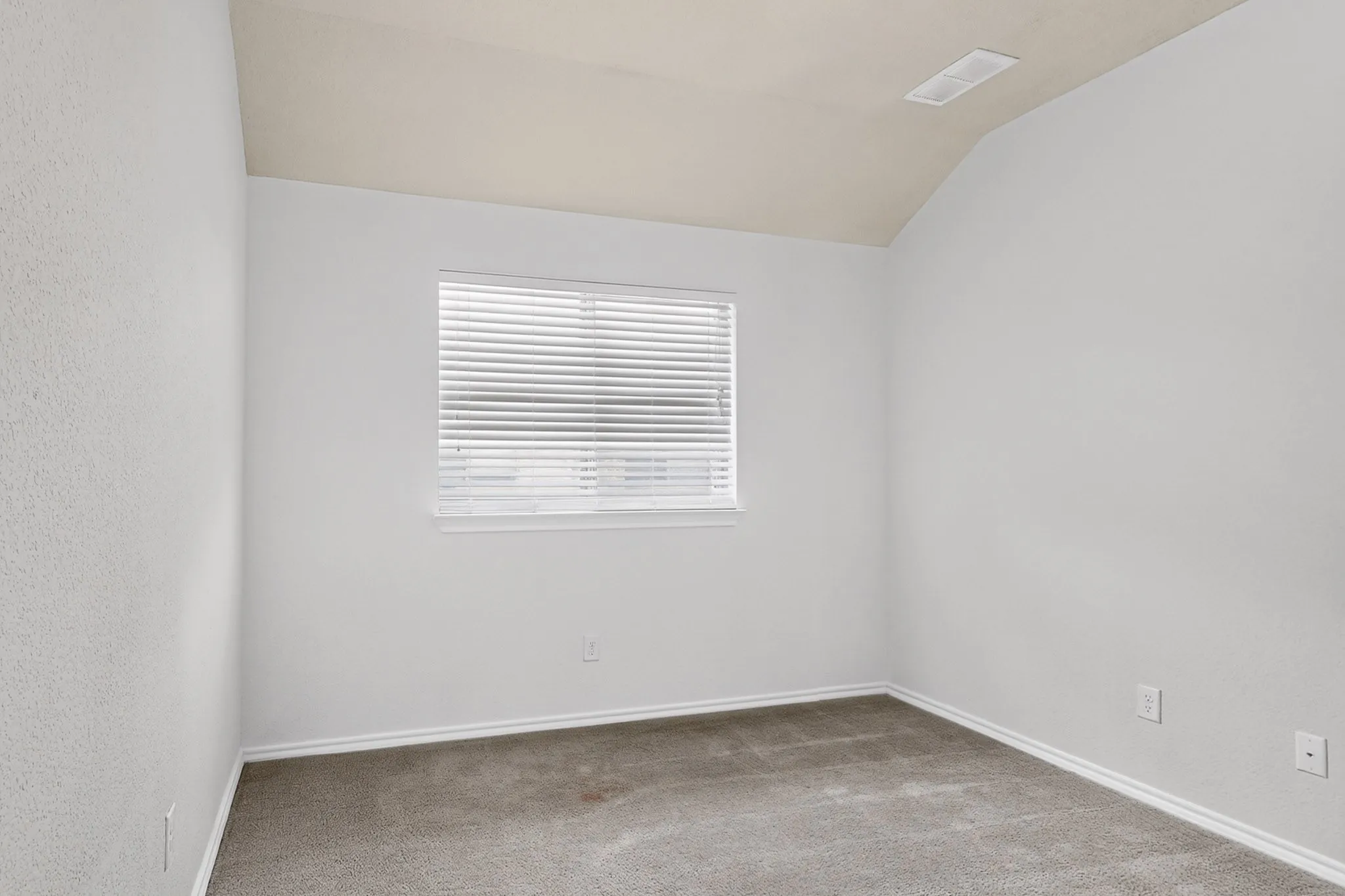Carpeted flooring, white walls, white window blinds, and sloped ceiling