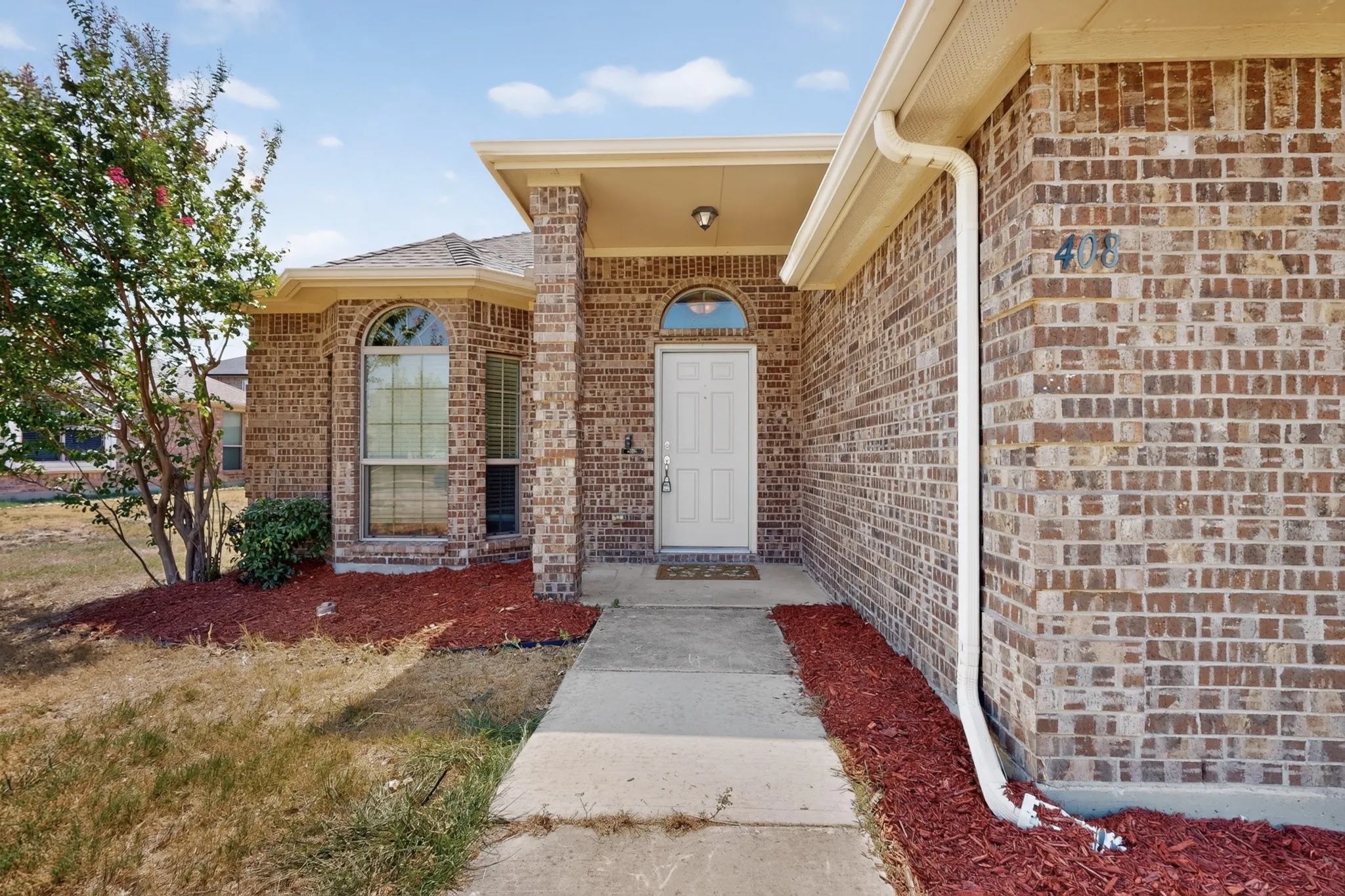 Brick exterior with a covered entry