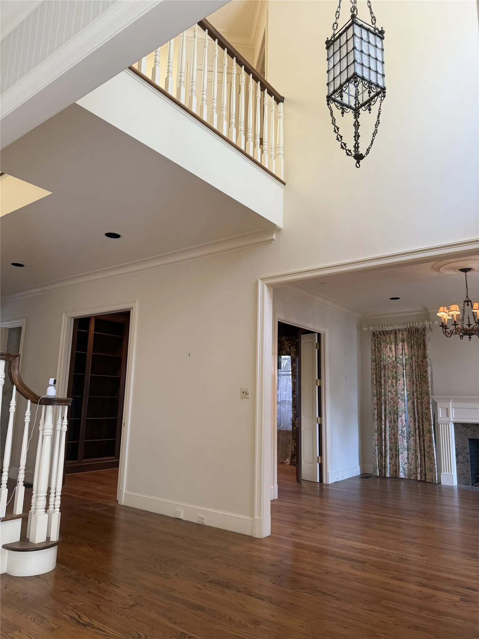 3632 McFarlin, 2 story entry, looking into formal living with fireplace. Doors lead into the library, office.
