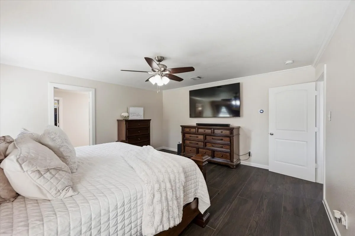 Recessed lighting, crown molding, wood-finish flooring, ceiling fan with light fixture, and white interior doors