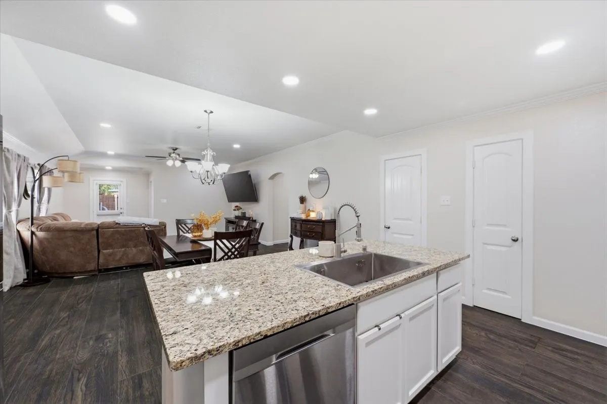 Kitchen island with granite countertop and stainless steel sink