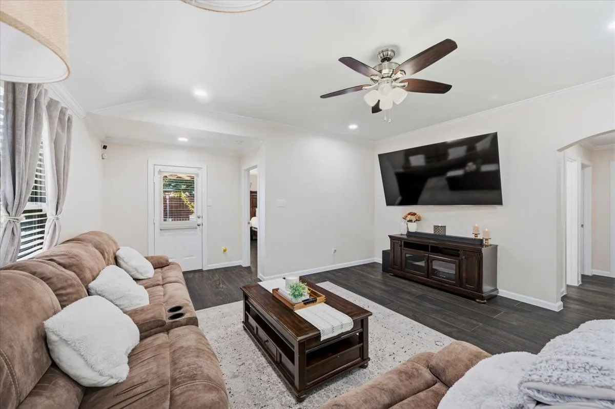 Dark wood-finish flooring, recessed lighting, and a ceiling fan with light kit