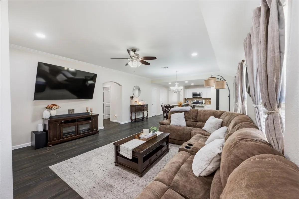 Recessed lighting, wood-finish flooring, and an arched doorway