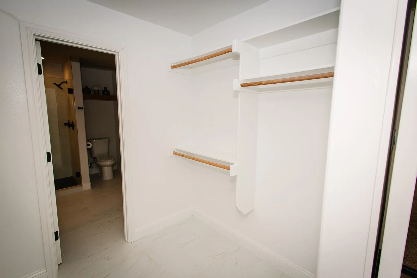 Custom closet system featuring built-in shelving and hanging rods