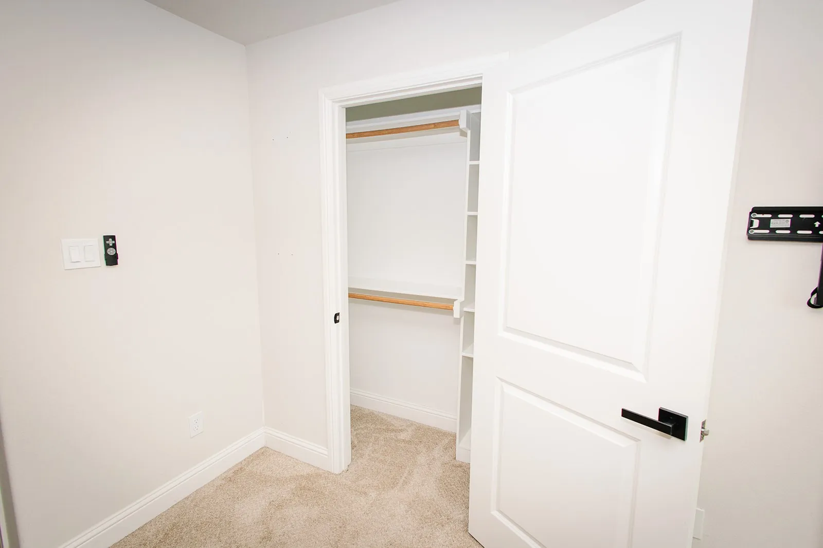2nd closet in master Closet with wood-finish shelving and hanging rod