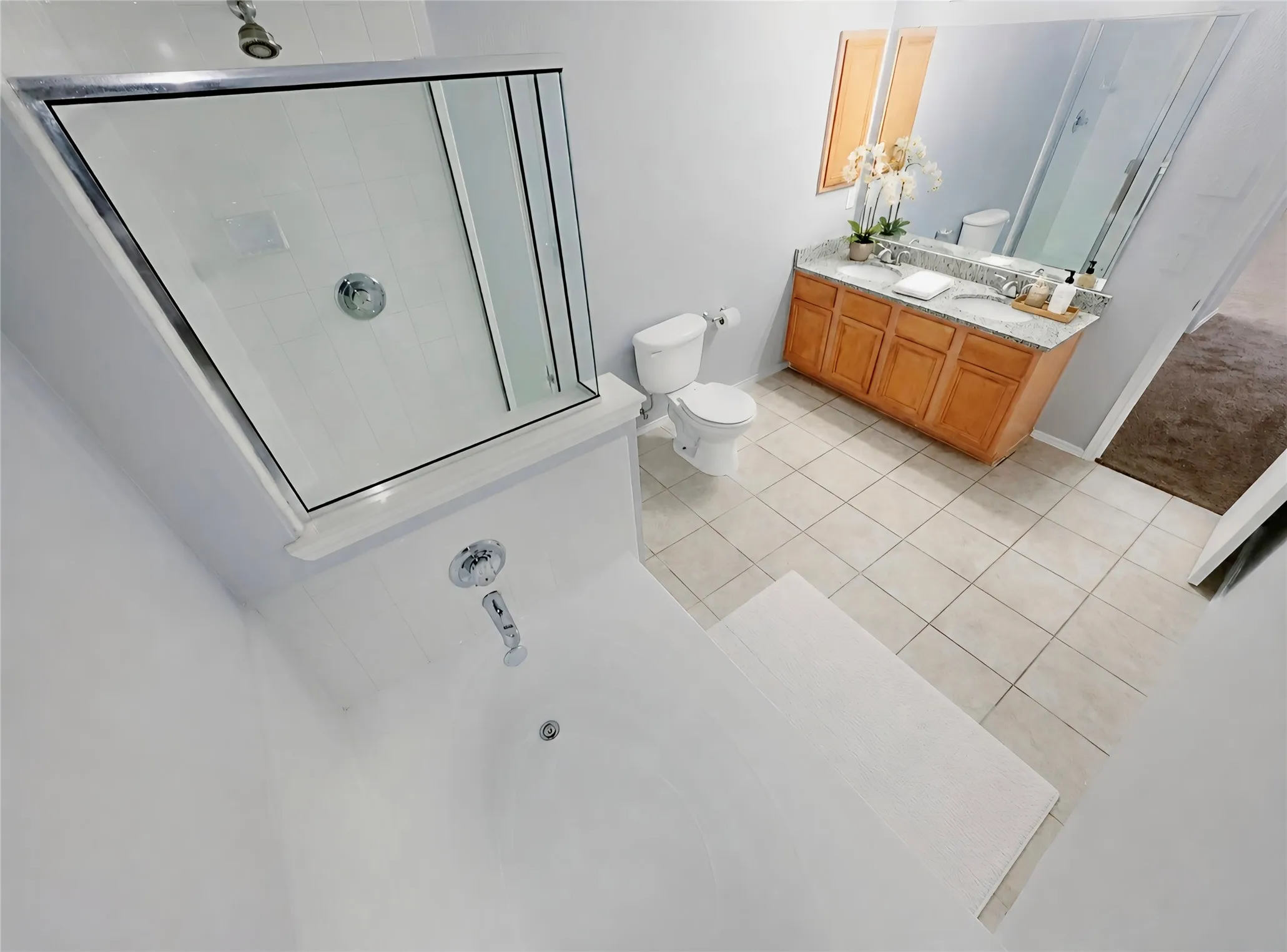 Dual sinks with wood-finish cabinetry, granite countertop.