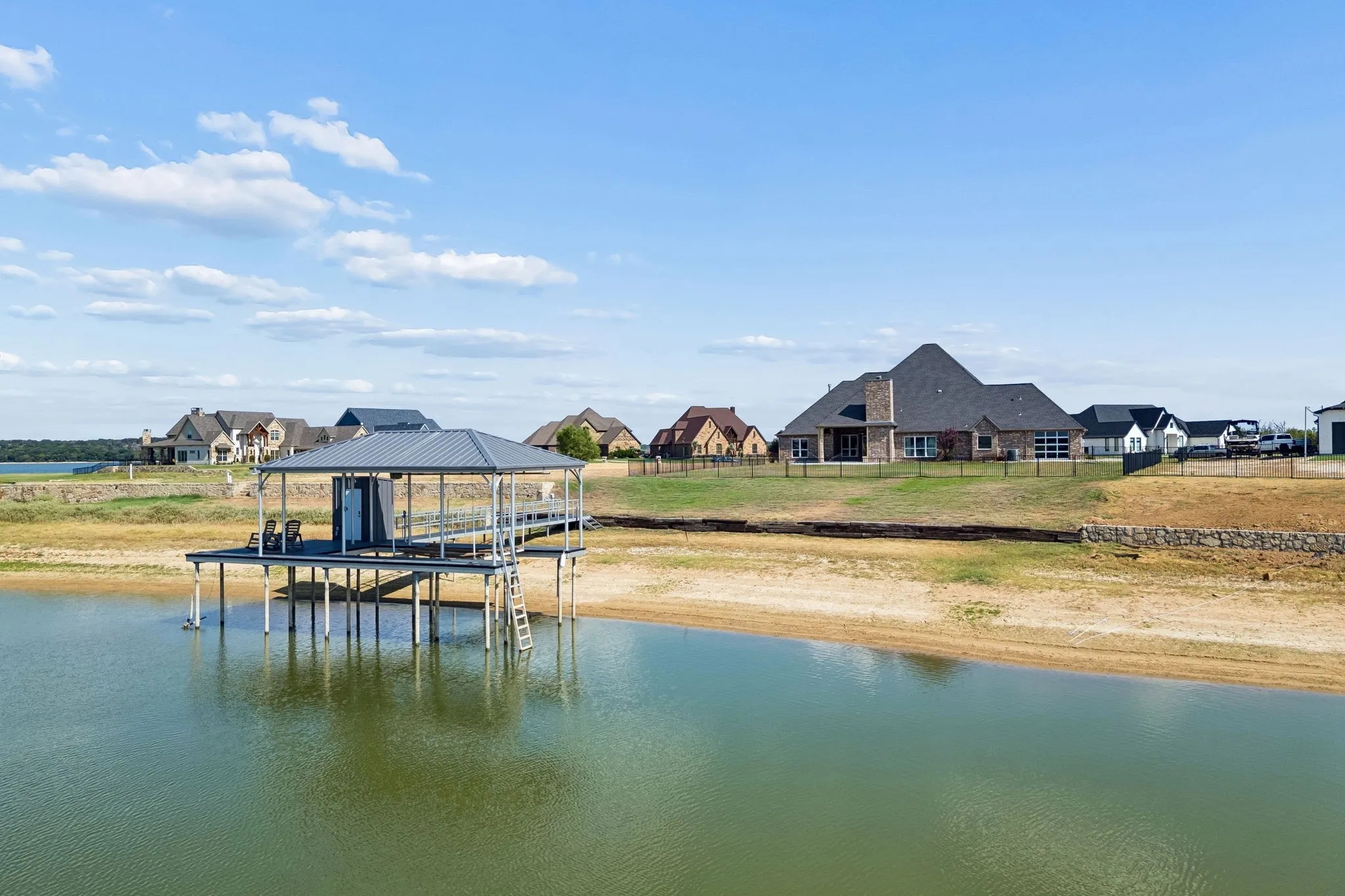 Waterfront property featuring a private boat dock with a covered slip and ladder access