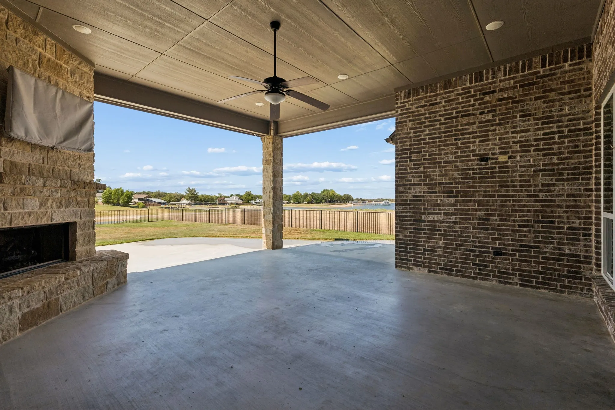 Gorgeous covered patio with wood burning fireplace and gas starter