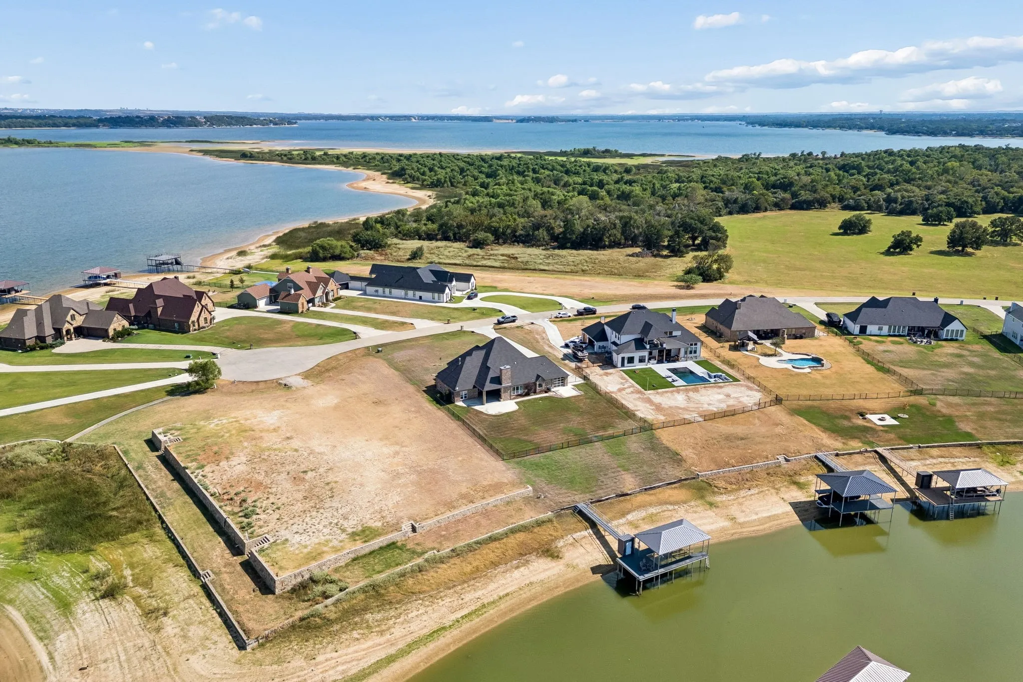 Expansive waterfront property with multiple private boat docks and surrounding natural landscape