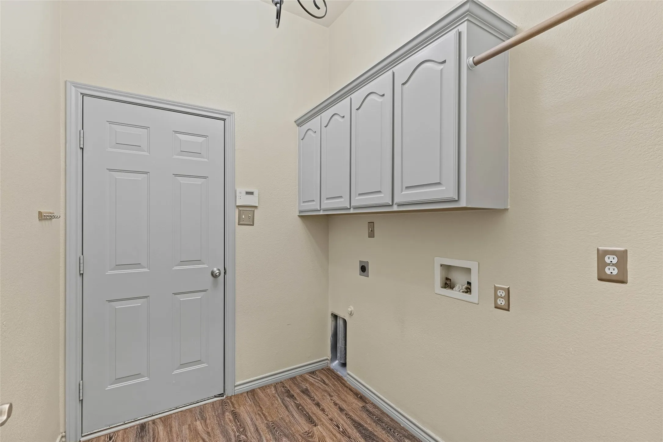 Built-in cabinetry, wood-finish flooring, and a laundry hookup