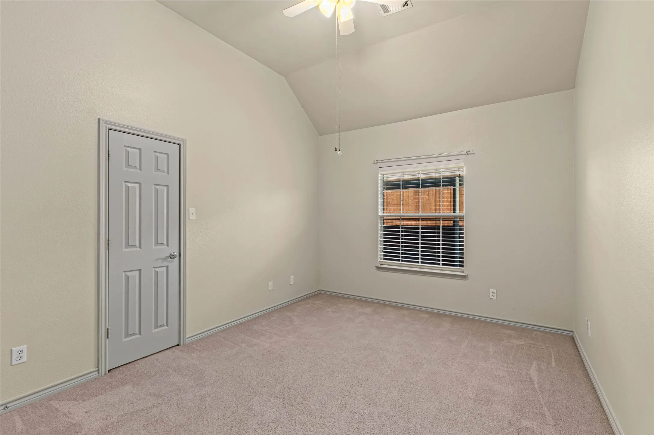 Neutral-toned walls complement plush carpeting
