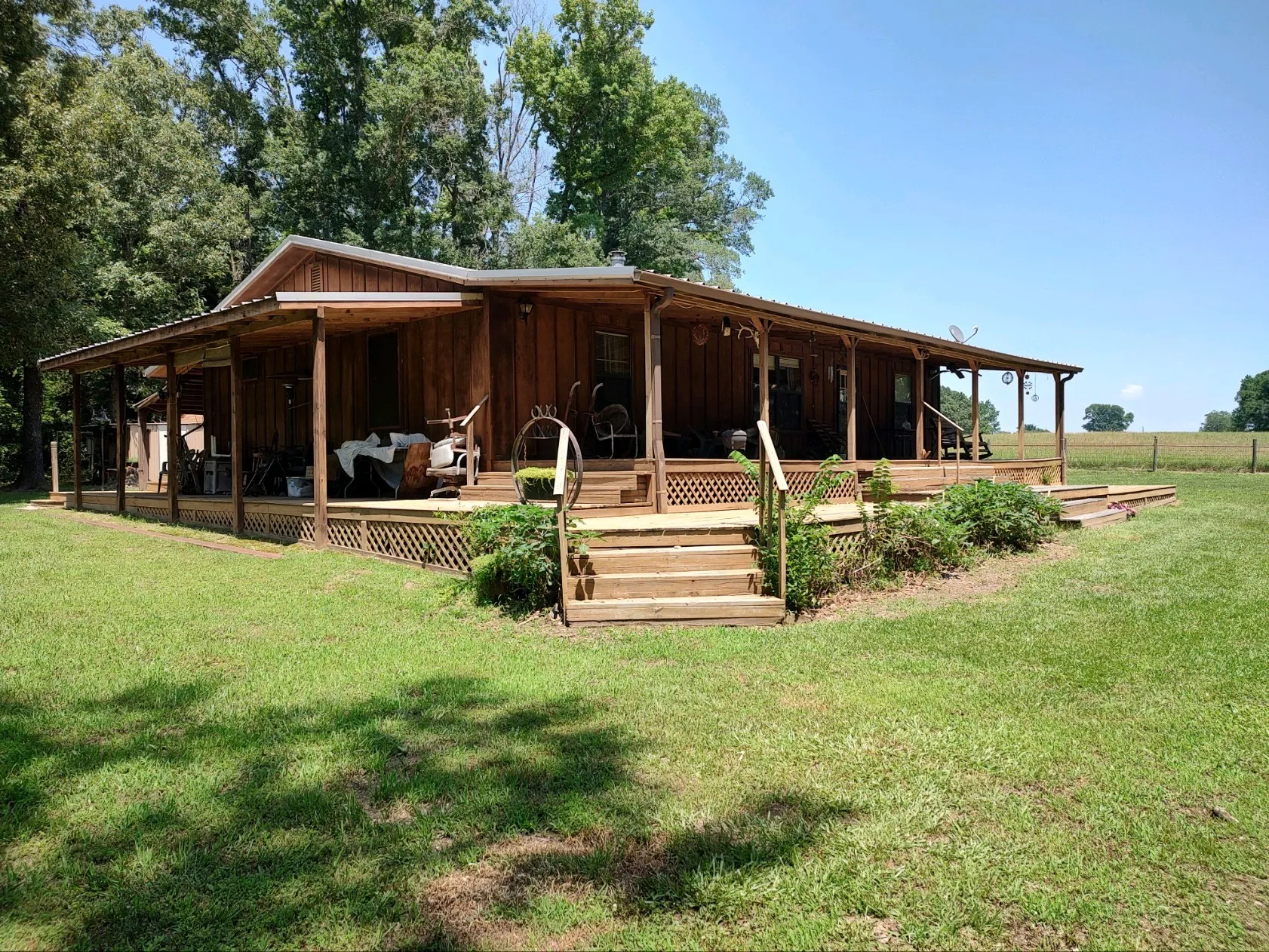 Front view of property with covered porch and deck.