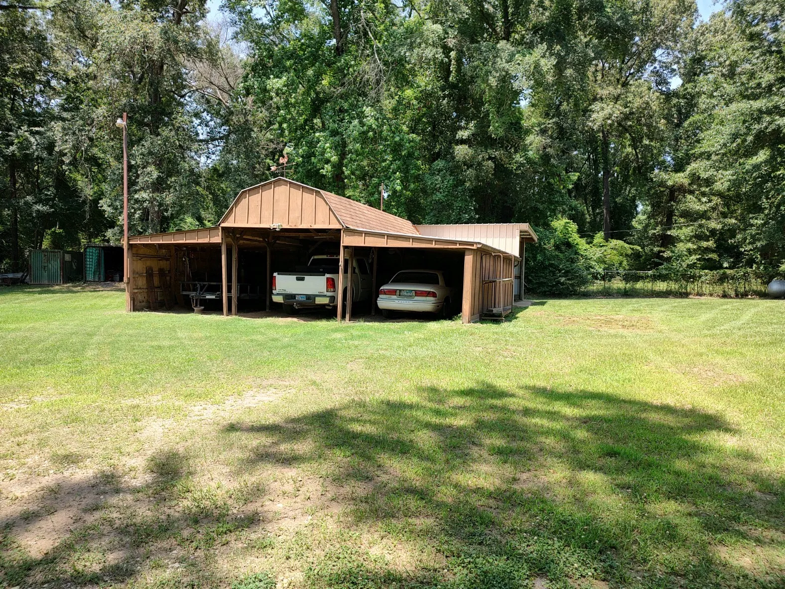 3-car carport with electricity, loft and shedrow behind.
