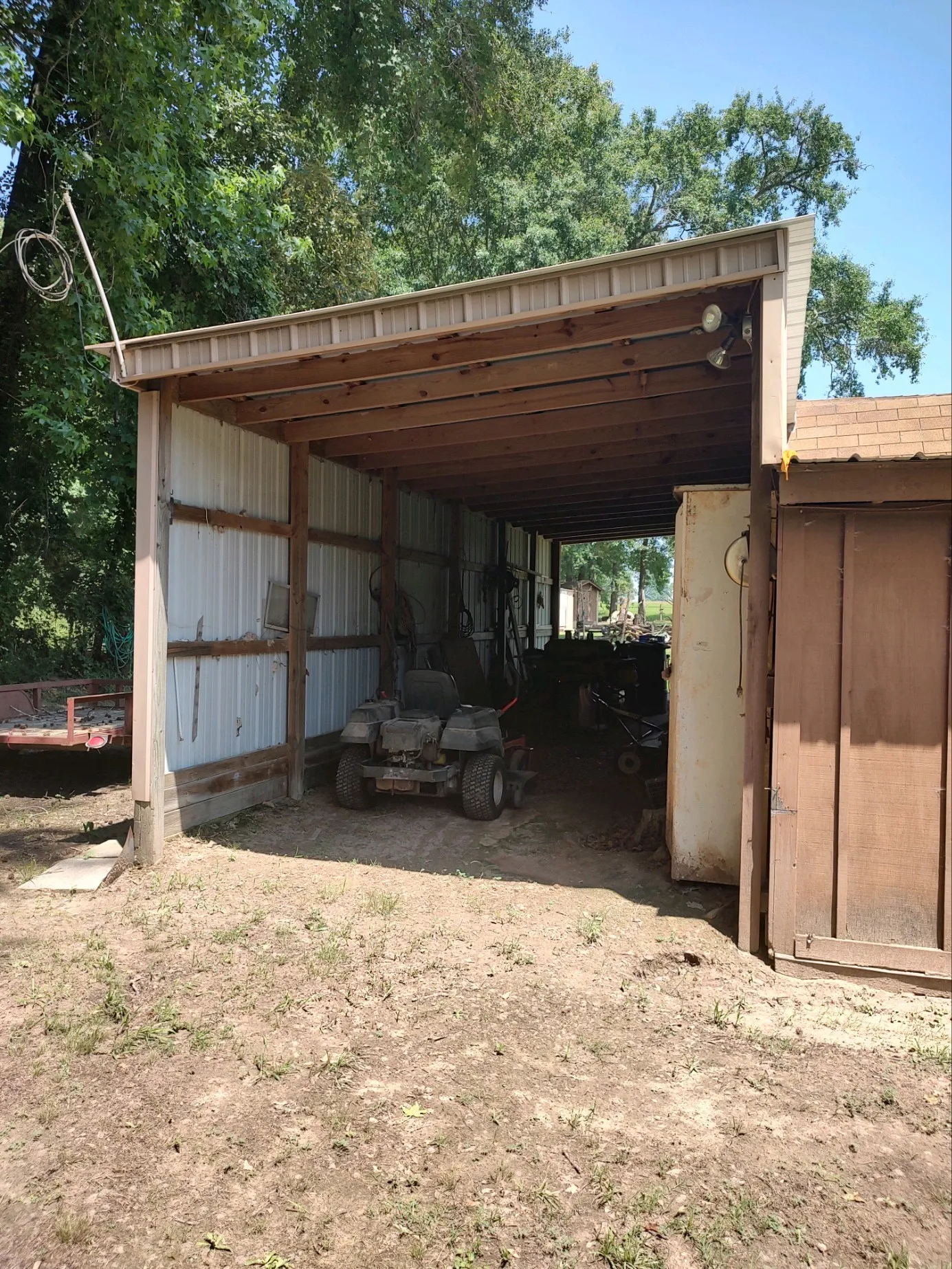 Drive-through shedrow with electricity attached to carport.