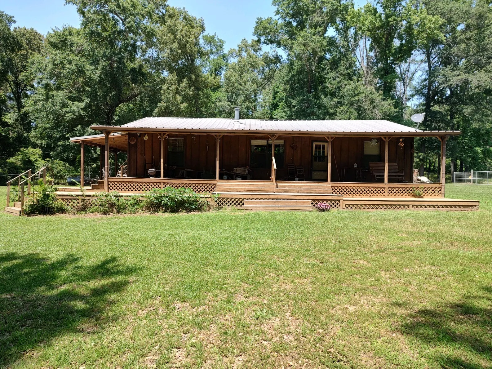 Front view of property with covered porch and deck.