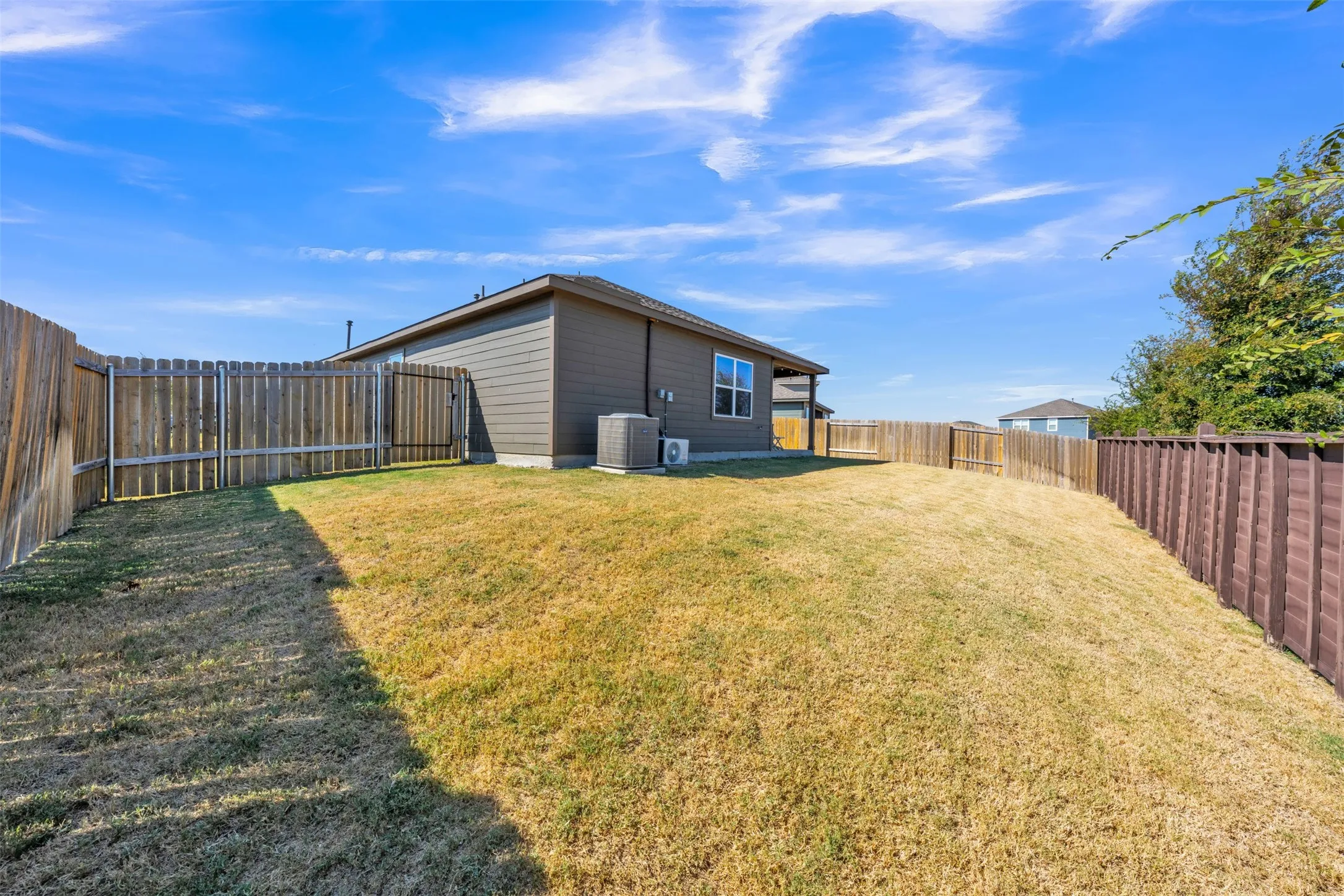 Expansive community park featuring a water body with fountains, walking paths, and green spaces