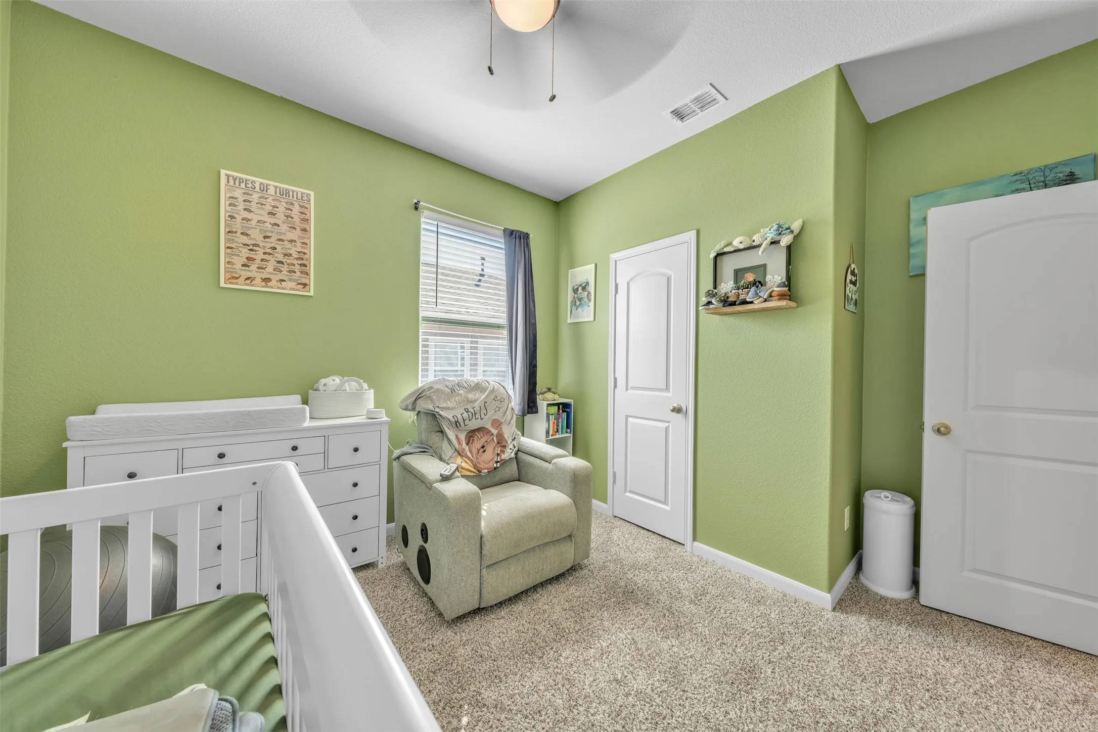 Carpeted flooring, a window with blinds, and white panel doors