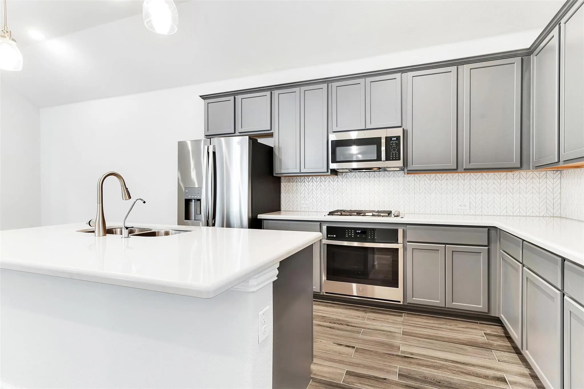 Stainless steel appliances, oversized kitchen island with bar seating, and plenty of cabinet space
