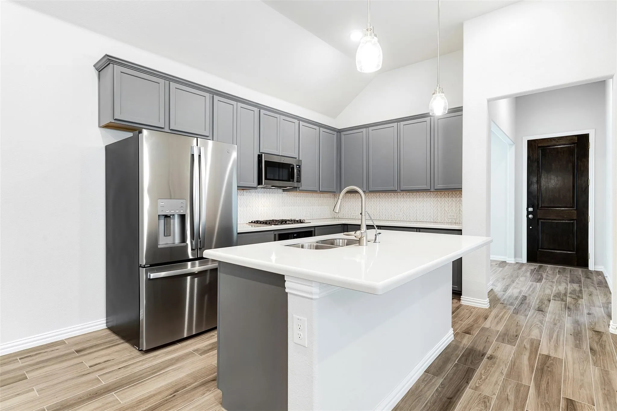 Stainless steel appliances, oversized kitchen island with bar seating, and plenty of cabinet space