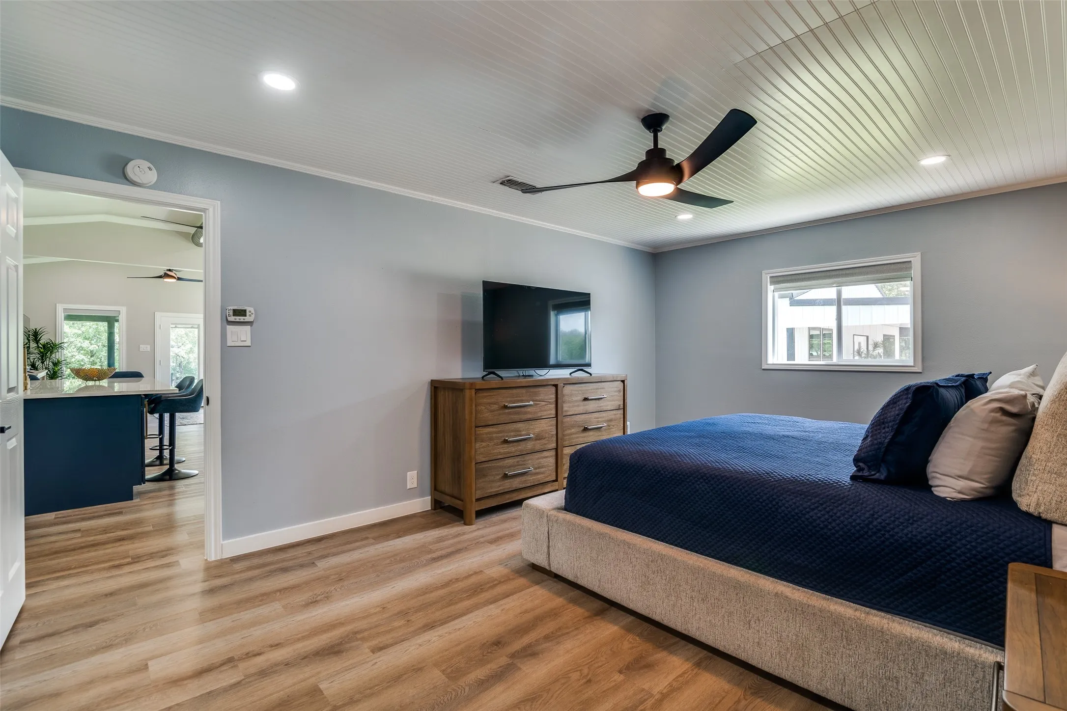 Wood-finish flooring, recessed lighting, and a ceiling fan with integrated lighting